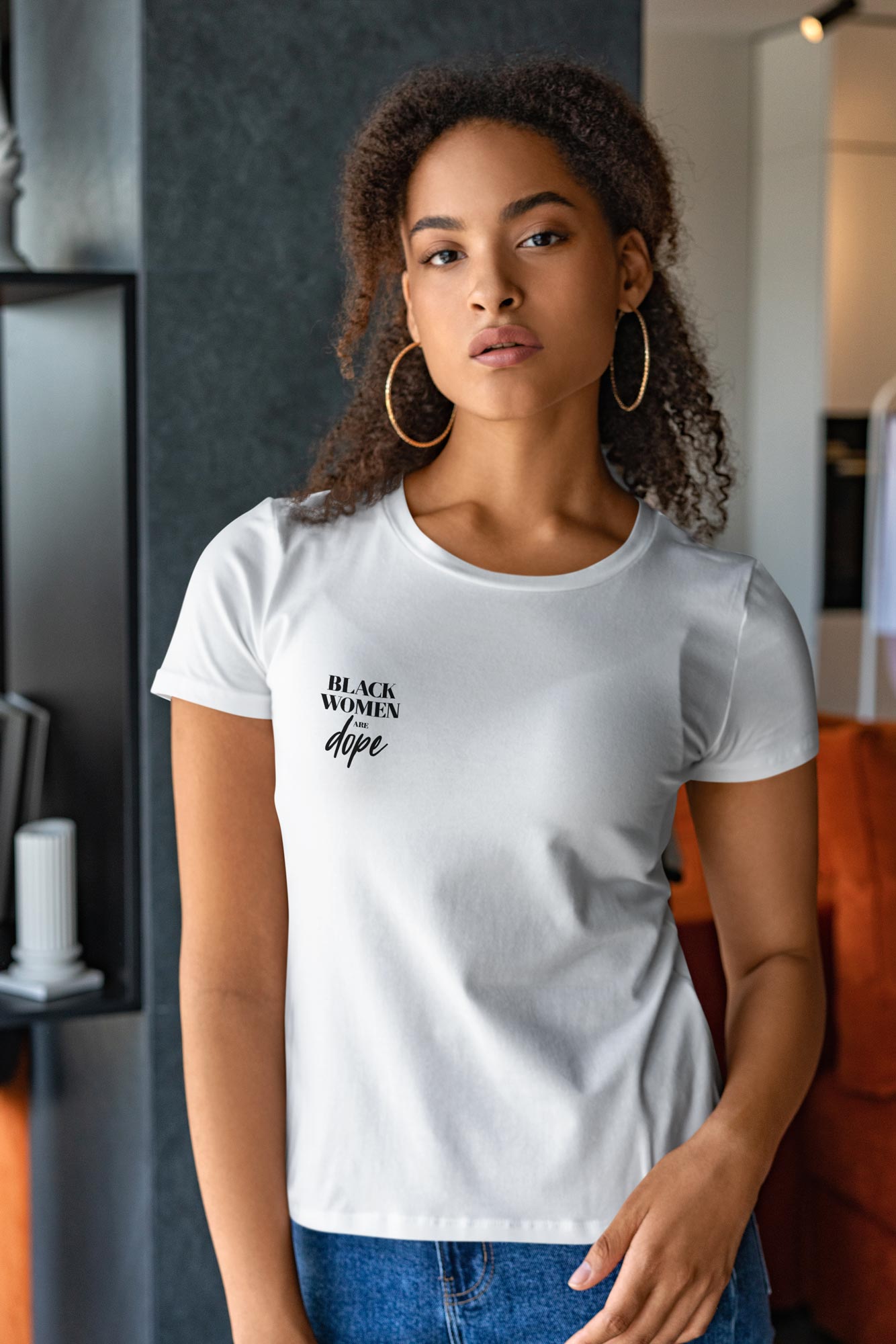 Woman in a white t shirt that has black women are dope written in black