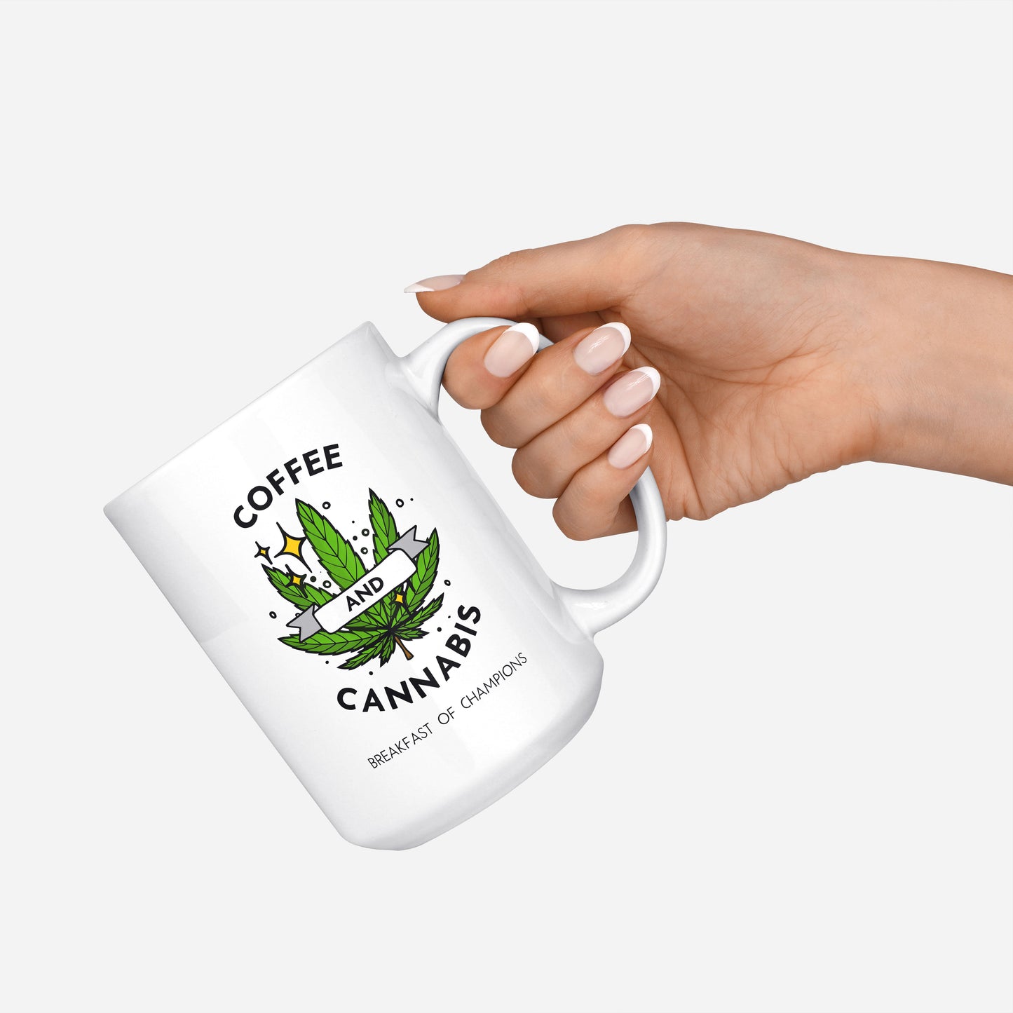 Coffee and Cannabis written on a white ceramic mug with a green marijuana leaf half in hand