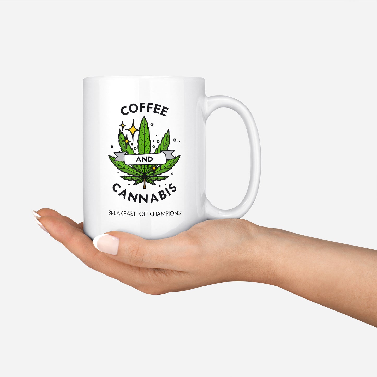 Coffee and Cannabis written on a white ceramic mug with a green marijuana leaf held in hand