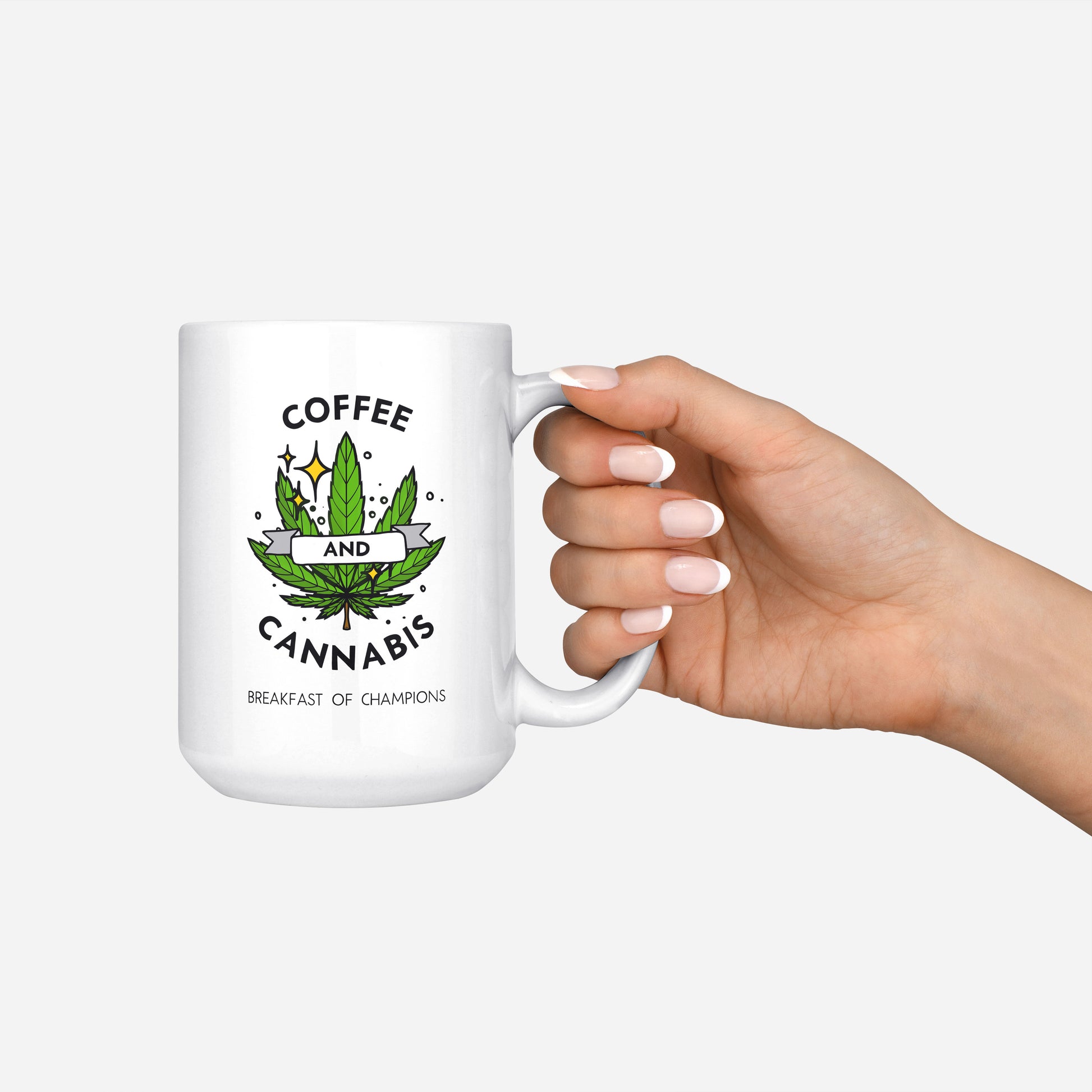 Coffee and Cannabis written on a white ceramic mug with a green marijuana leaf held by the handle