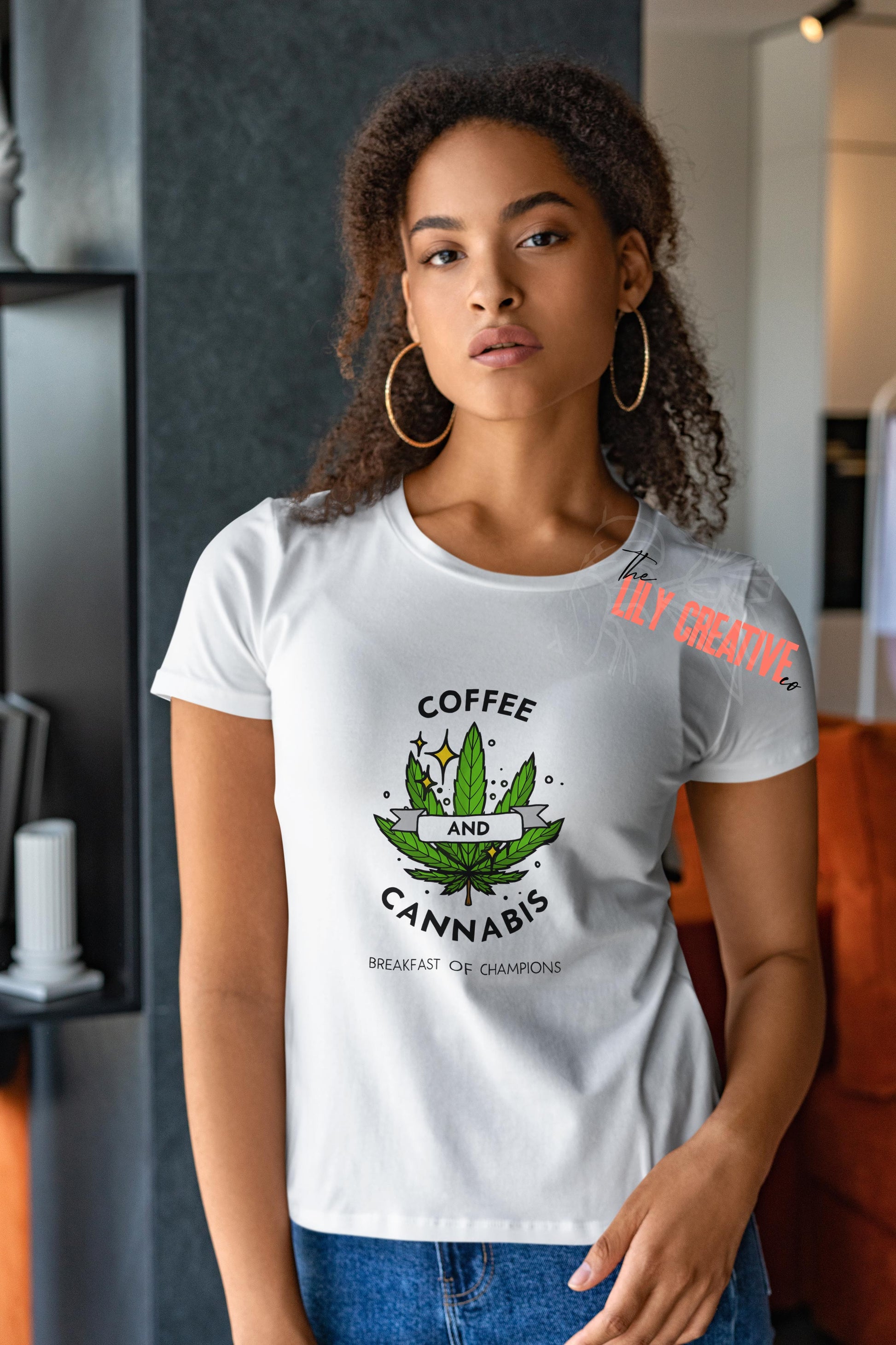 Woman in a white t shirt that says coffee & cannabis with a marijuana leaf