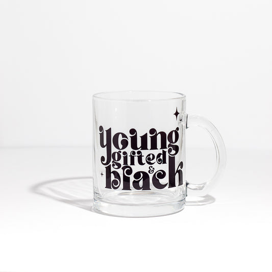 "Young, Gifted & Black" written on a clear glass mug.